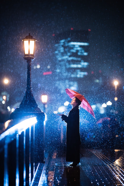 woman standing aside of the light on a bridge in Osaka