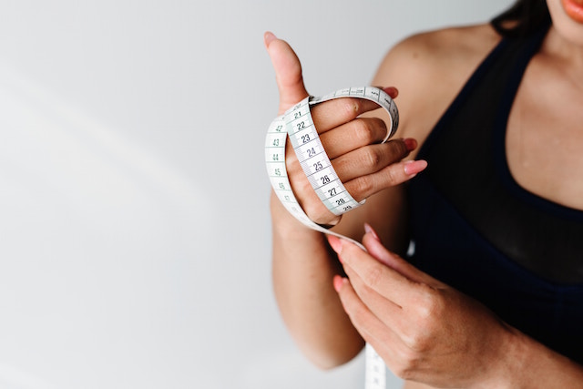 woman holding a measure in her hands